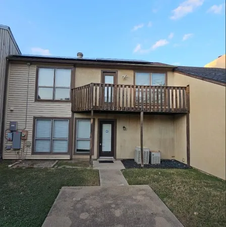a view of a house with a yard and deck