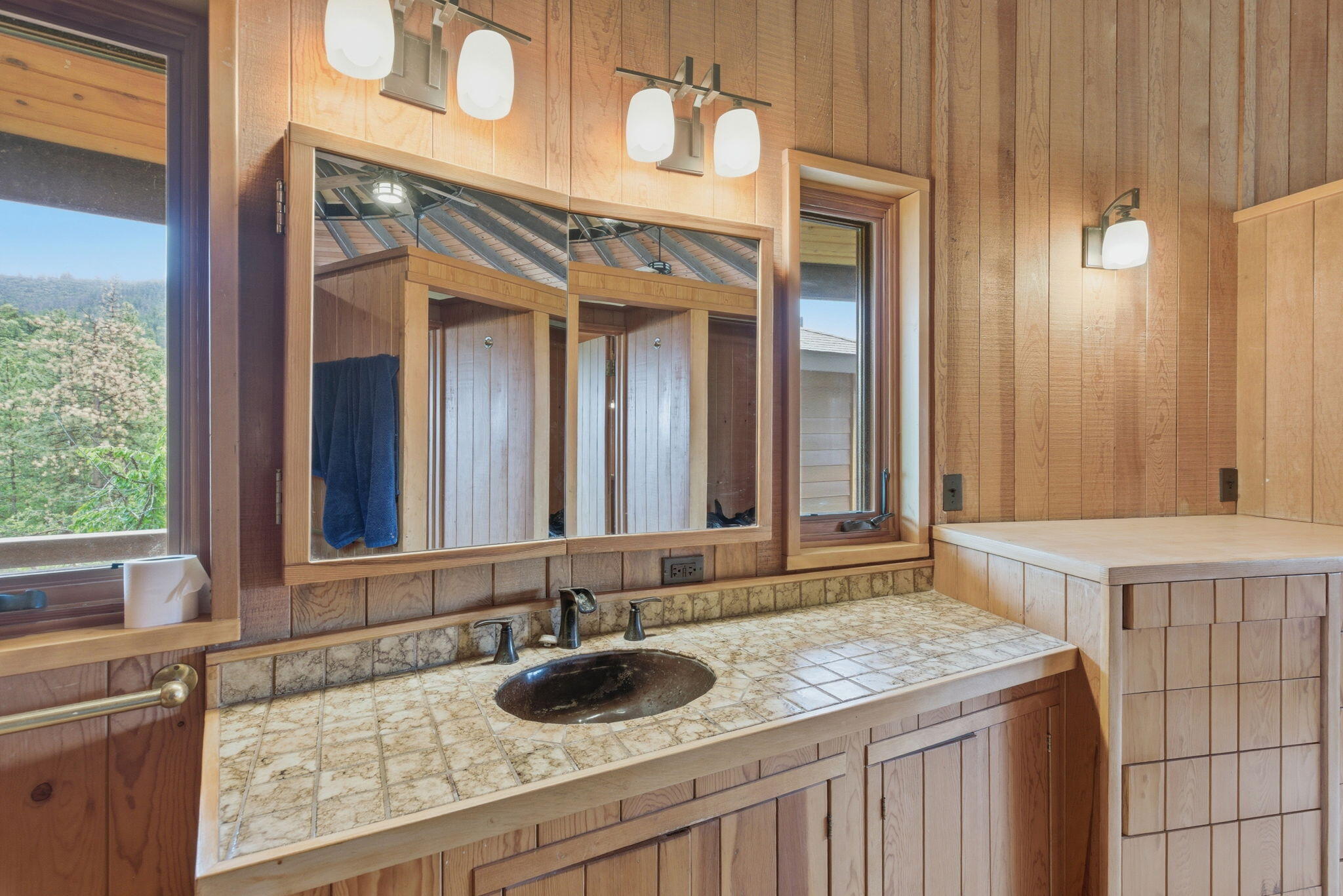 9595 Sterling Creek Road Jacksonville, OR 97530 - Photo 20 of 76 a bathroom with a granite countertop sink and a mirror