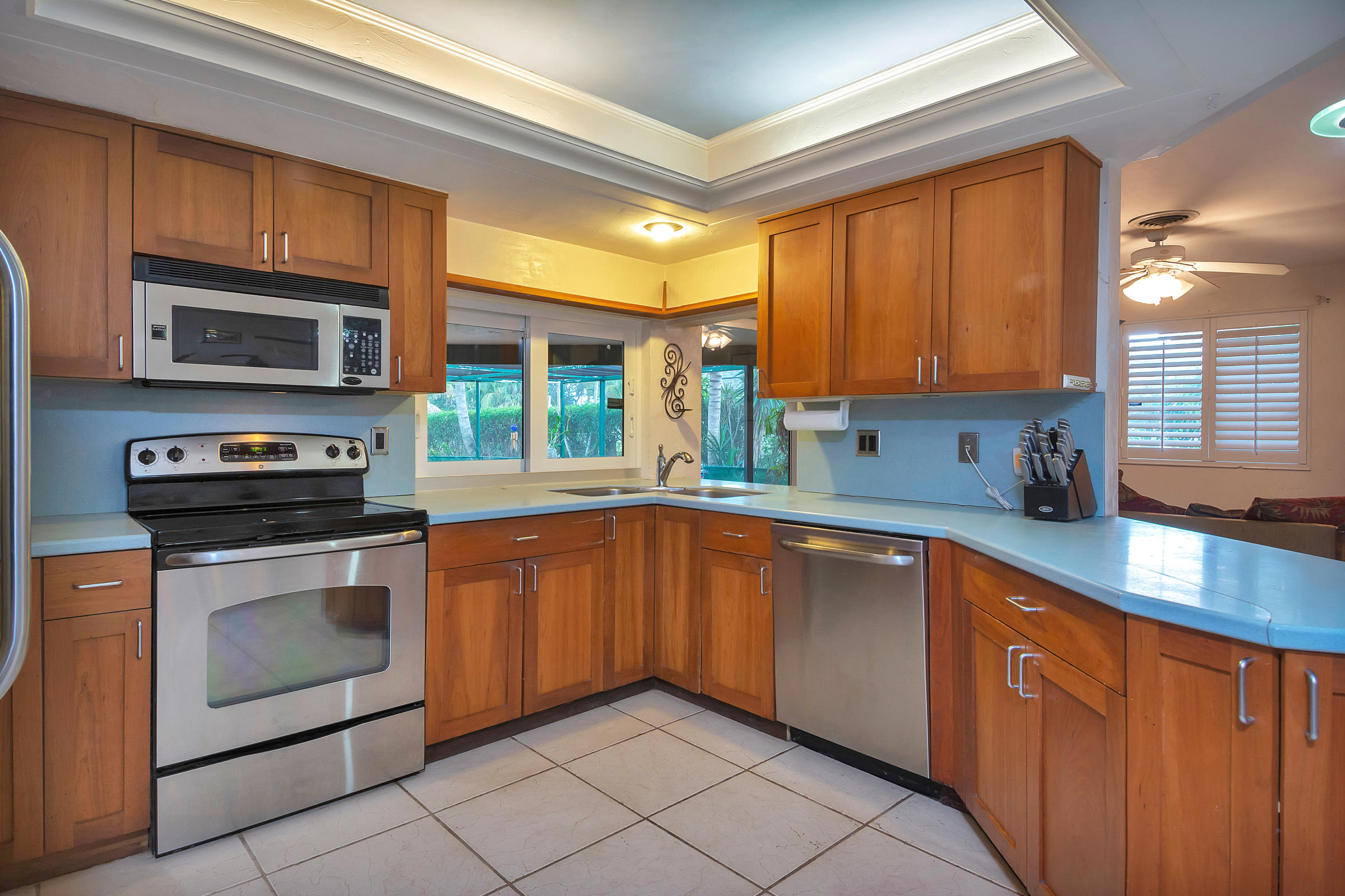 400 Northwest 11th Street Boca Raton, FL 33432 - Photo 12 of 42 a kitchen with stainless steel appliances granite countertop a stove sink and microwave