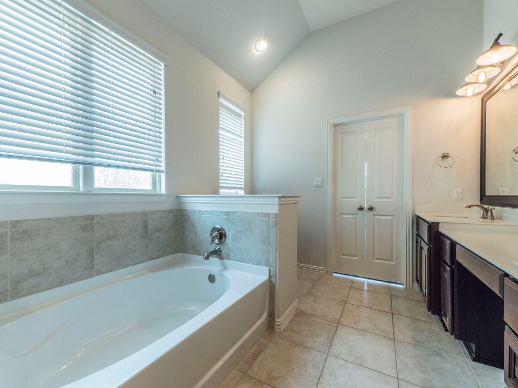 244 Fort Cobb Way Georgetown, TX 78628 - Photo 15 of 29 a bathroom with a bathtub and a sink