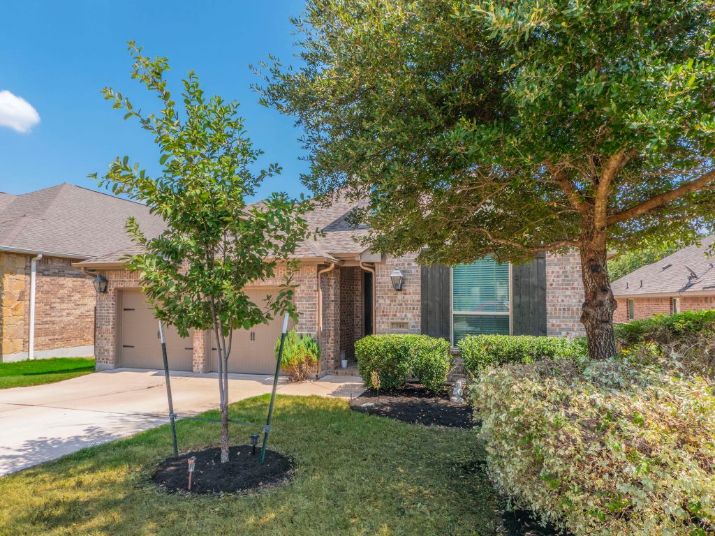 244 Fort Cobb Way Georgetown, TX 78628 - Photo 23 of 29 a front view of a house with a garden