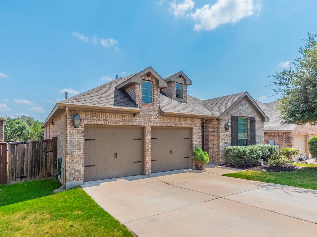 244 Fort Cobb Way Georgetown, TX 78628 - Photo 24 of 29 a front view of a house with garden