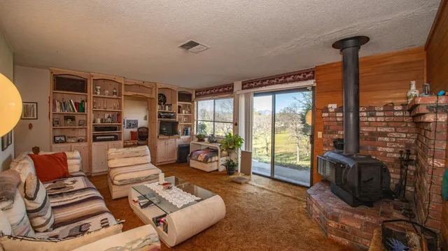 a living room with furniture and a floor to ceiling window