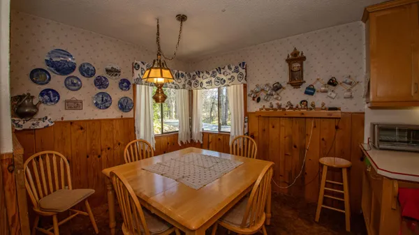 a dining room with furniture and window