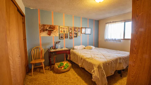 a bedroom with a bed and a chair