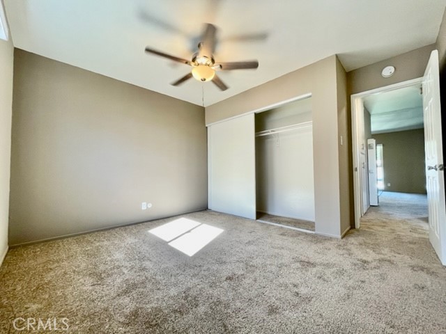 815 North Rose Avenue, Unit J Compton, CA 90221 - Photo 14 of 22 an empty room with a chandelier fan and closet