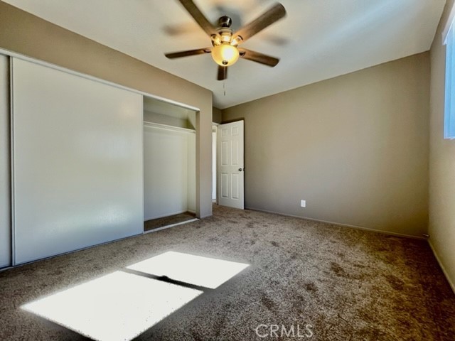 815 North Rose Avenue, Unit J Compton, CA 90221 - Photo 15 of 22 an empty room with a window and a ceiling fan