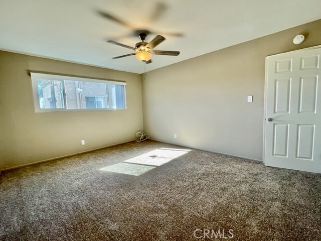 815 North Rose Avenue, Unit J Compton, CA 90221 - Photo 18 of 22 an empty room with a ceiling fan and window