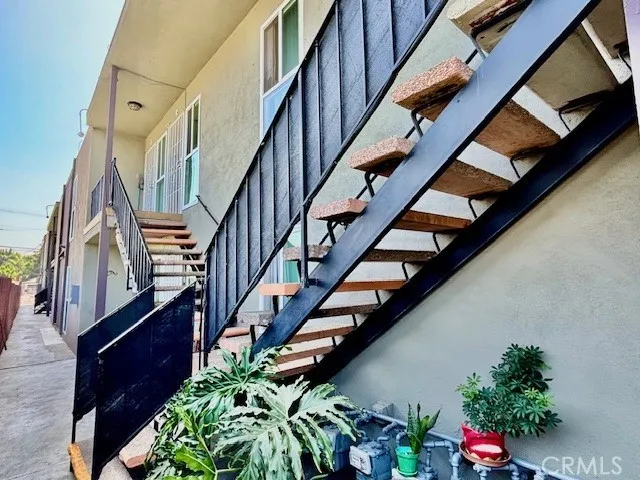 a view of entryway with wooden floor and a front door