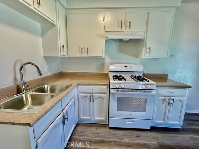 815 North Rose Avenue, Unit J Compton, CA 90221 - Photo 7 of 22 a kitchen with sink a stove and cabinets