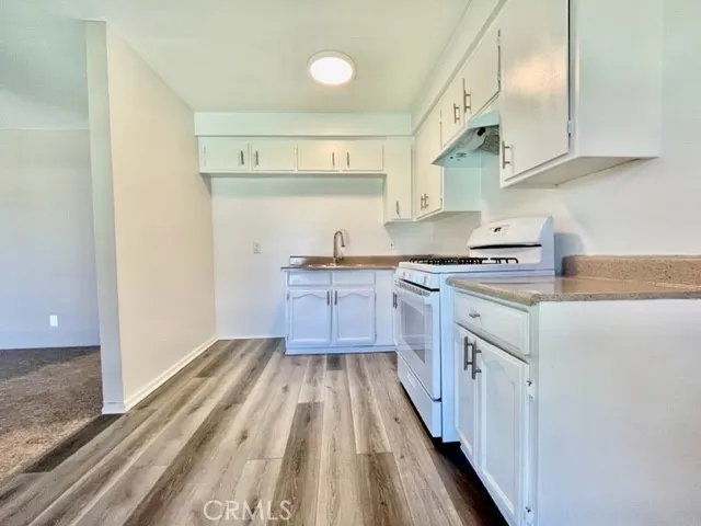 a kitchen with stainless steel appliances a stove a sink and a refrigerator