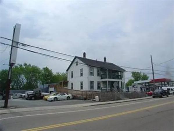 a view of a building and car parked on the road