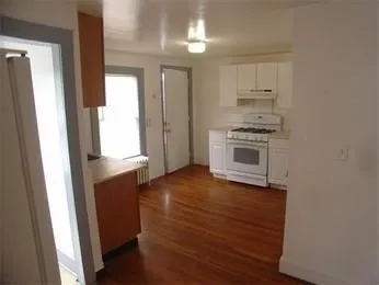 a kitchen with granite countertop a stove and a refrigerator