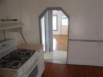a kitchen with granite countertop a stove and a refrigerator