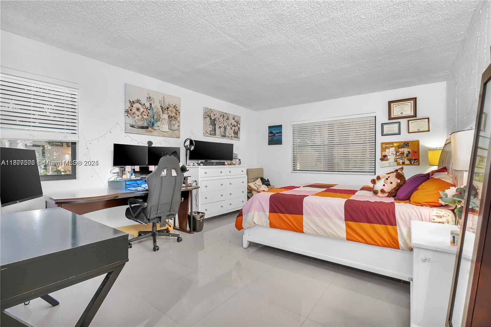 491 Ives Dairy Road, Unit 2025 Miami, FL 33179 - Photo 13 of 20 a bedroom with bed and window