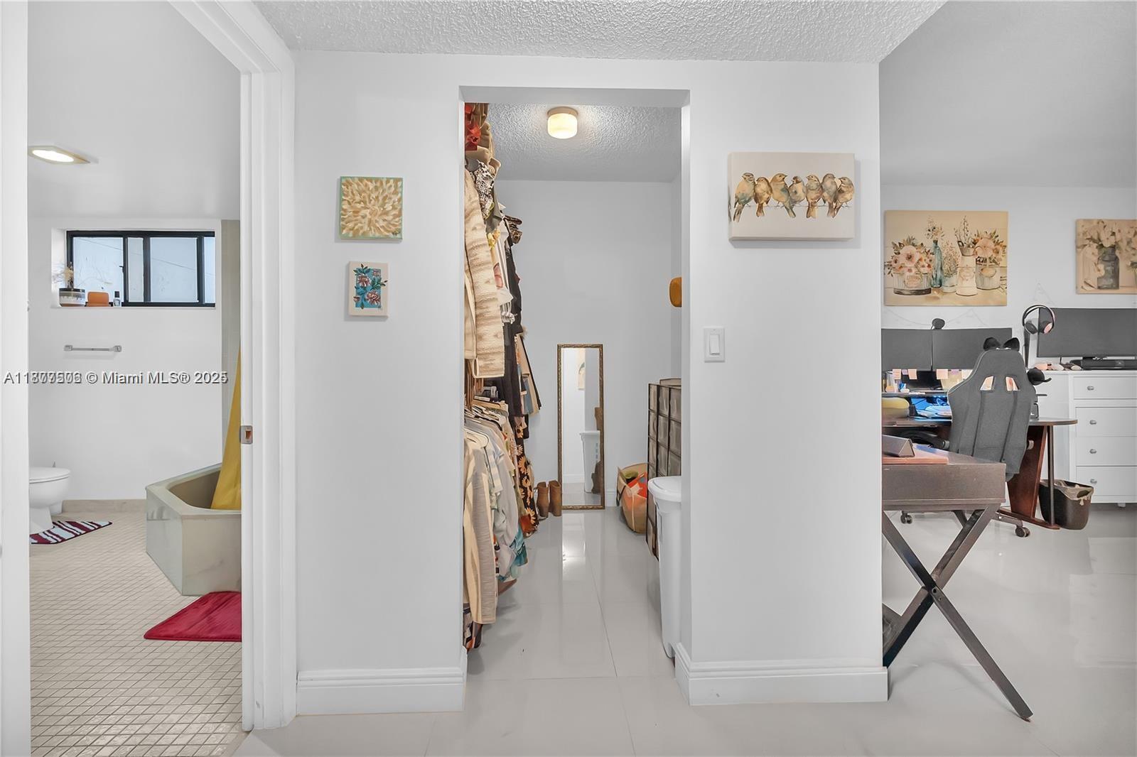 491 Ives Dairy Road, Unit 2025 Miami, FL 33179 - Photo 14 of 20 a view of a hallway with workspace and a window