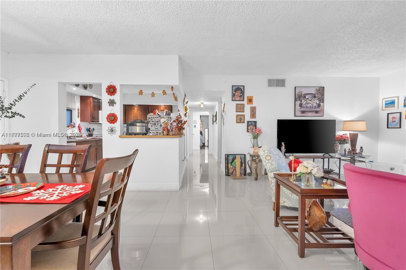 491 Ives Dairy Road, Unit 2025 Miami, FL 33179 - Photo 15 of 20 a living room with furniture and a flat screen tv