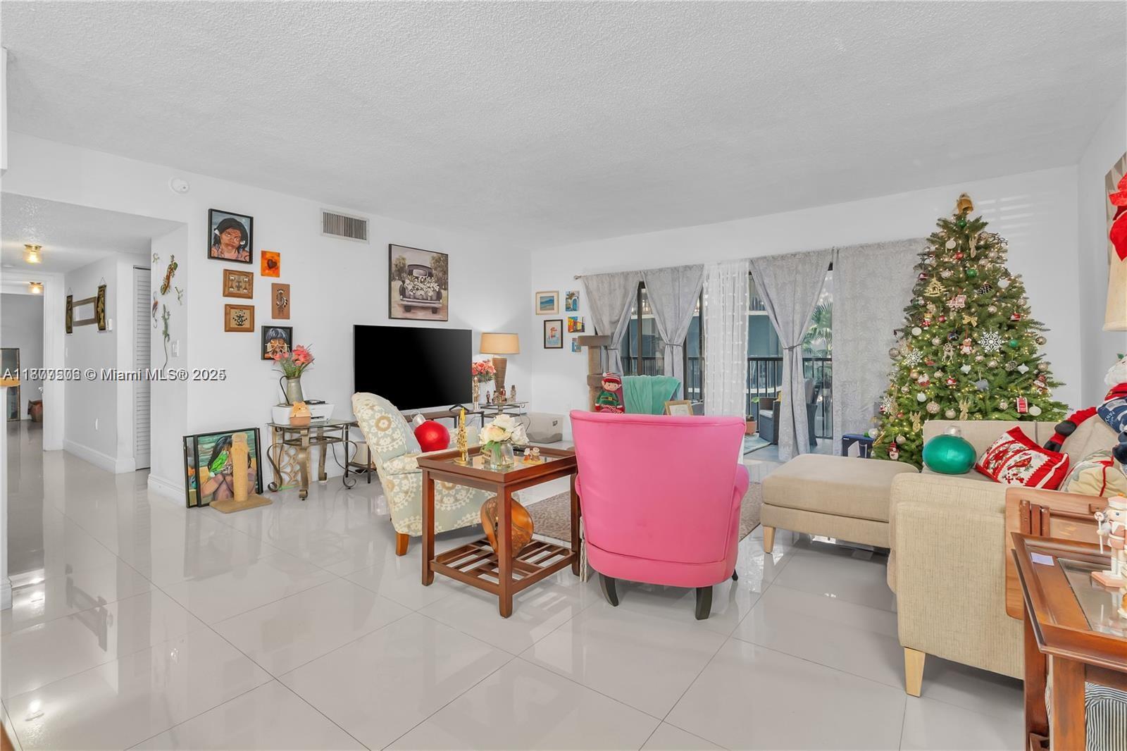 491 Ives Dairy Road, Unit 2025 Miami, FL 33179 - Photo 16 of 20 a living room with furniture and a flat screen tv