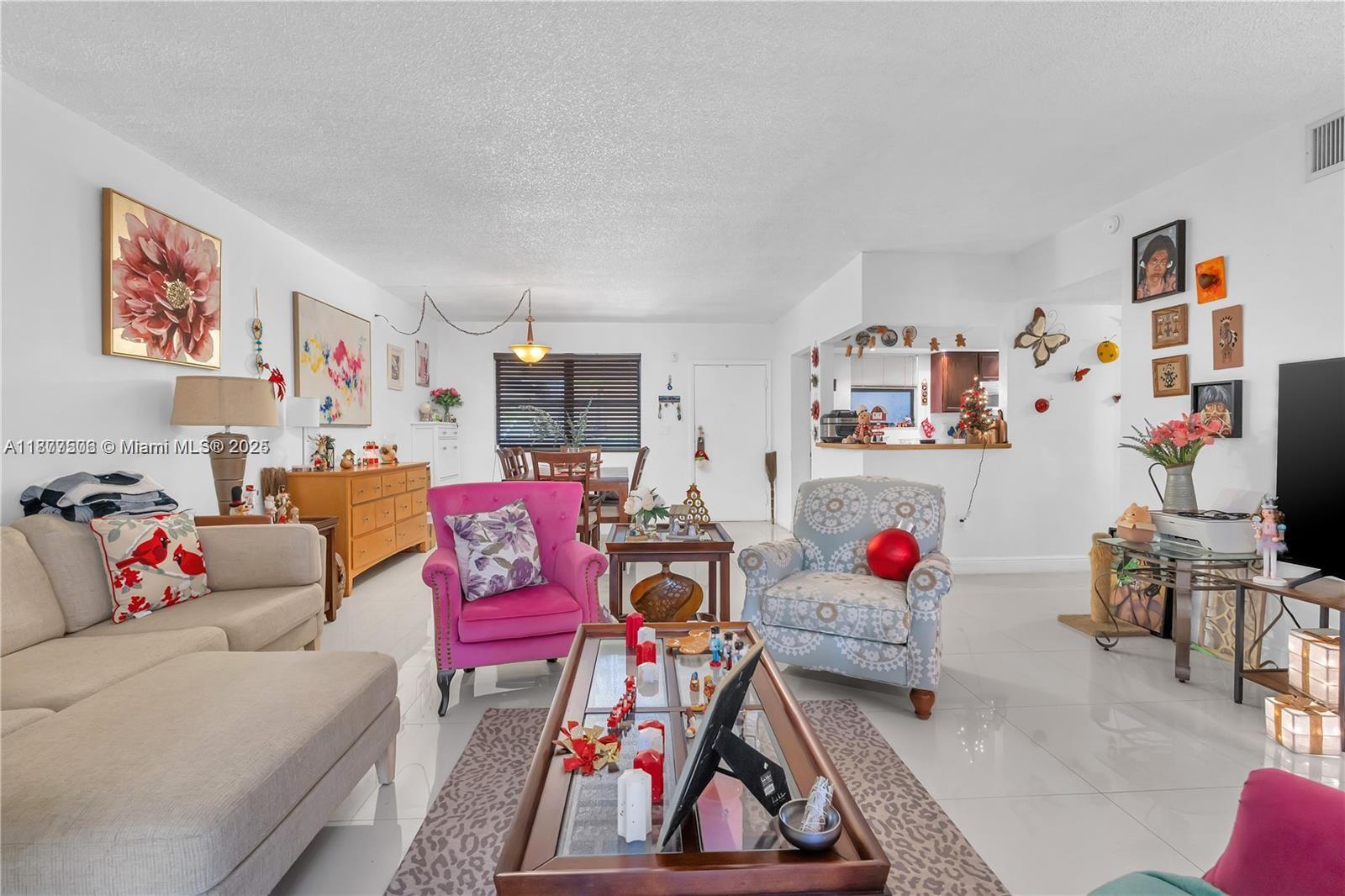 491 Ives Dairy Road, Unit 2025 Miami, FL 33179 - Photo 18 of 20 a living room with furniture and a white wooden floor