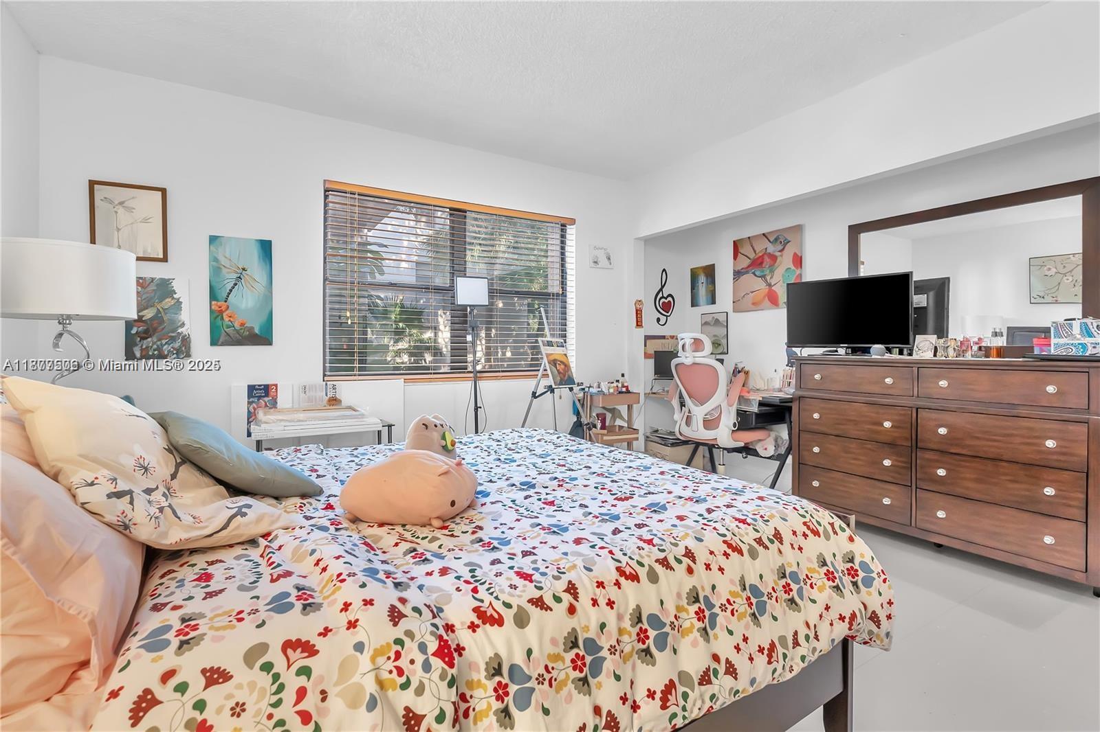 491 Ives Dairy Road, Unit 2025 Miami, FL 33179 - Photo 8 of 20 a bedroom with a bed and flat screen tv