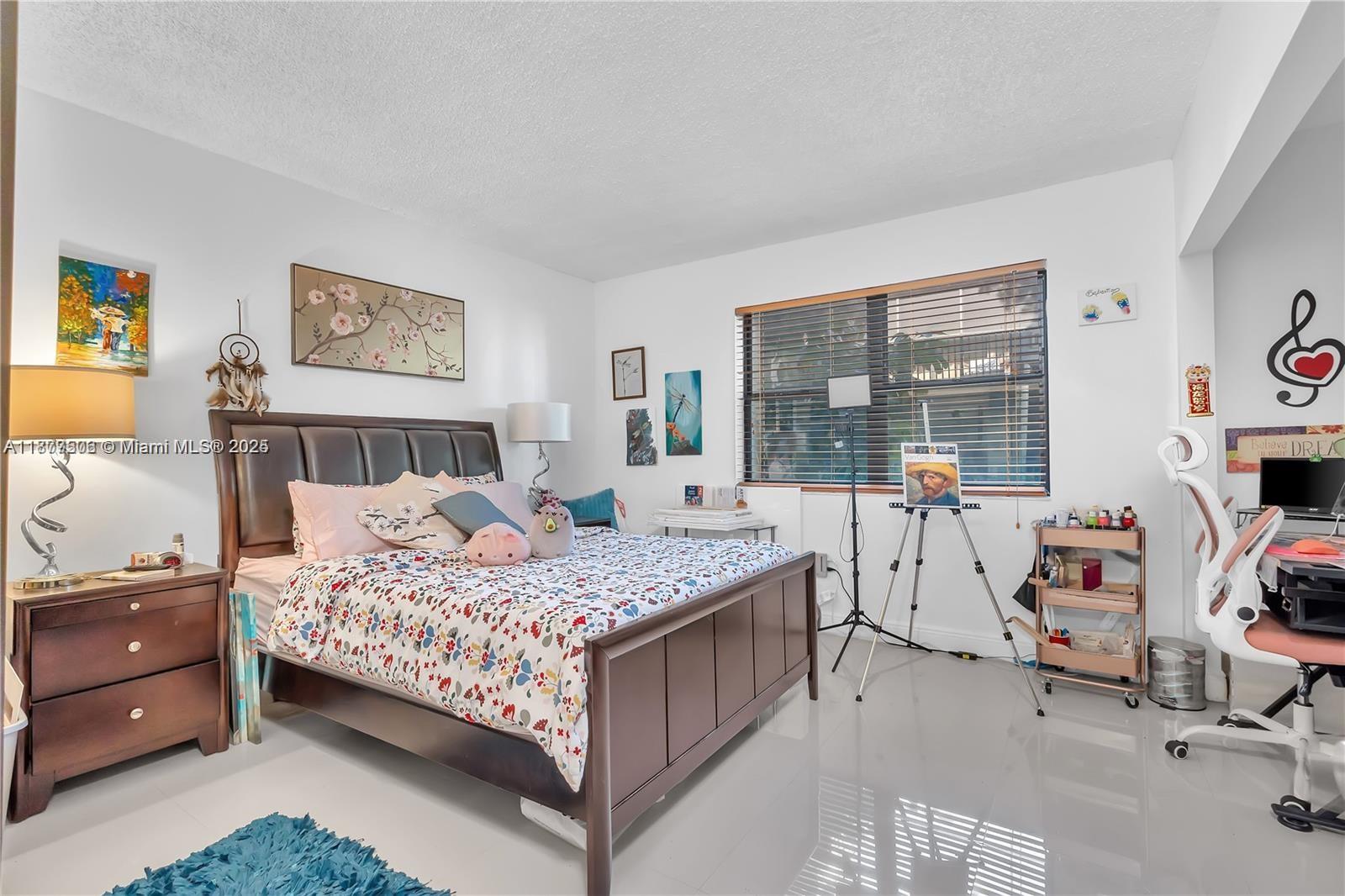 491 Ives Dairy Road, Unit 2025 Miami, FL 33179 - Photo 9 of 20 a bedroom with a bed couch and a window