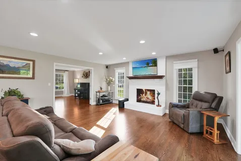 a living room with furniture and a fireplace