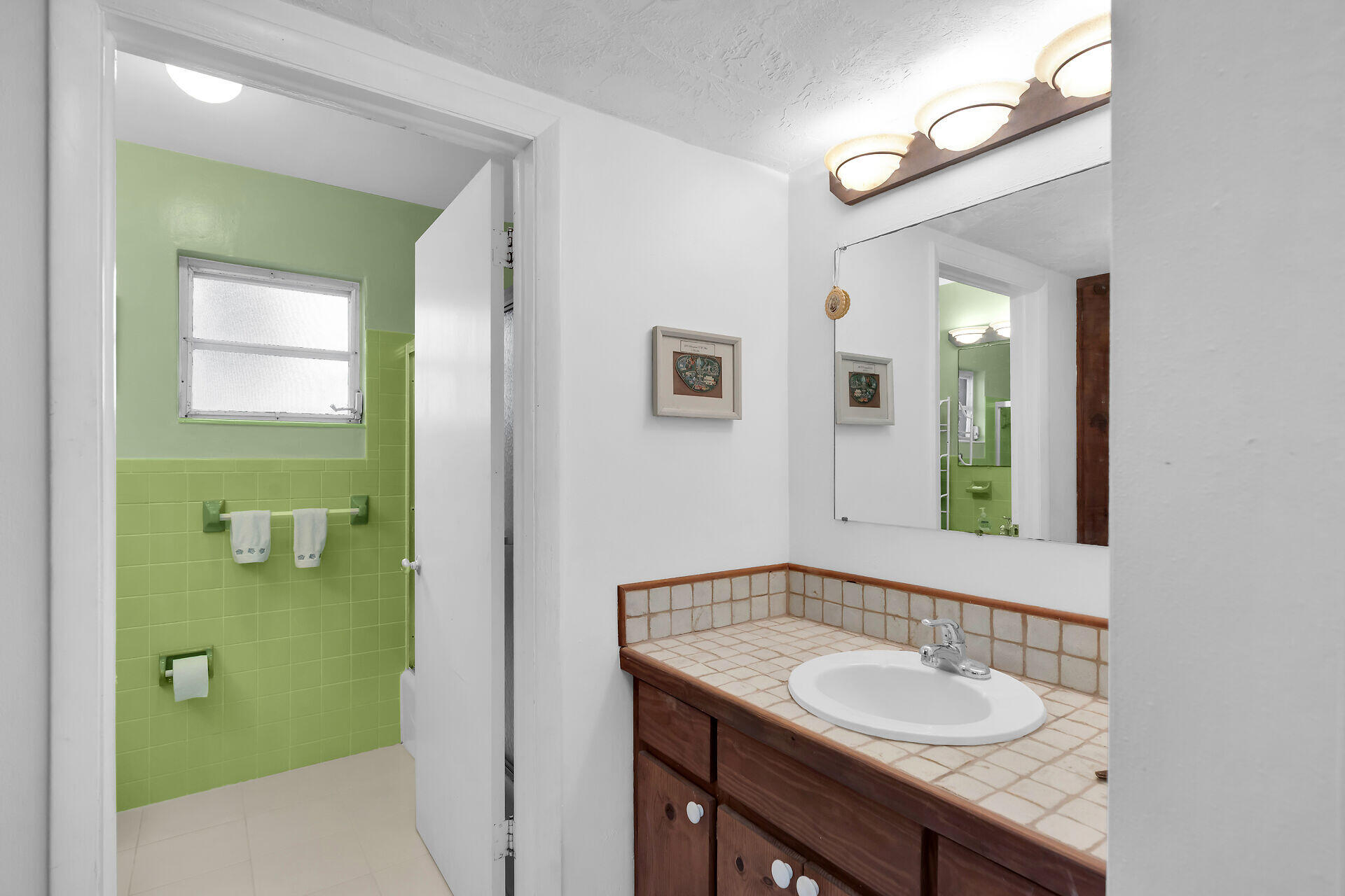 42 Treasure Road Marathon, FL 33050 - Photo 30 of 70 a bathroom with a granite countertop sink and a mirror