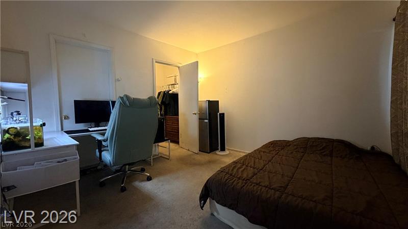 7255 West Sunset Road, Unit 2027 Las Vegas, NV 89113 - Photo 15 of 38 An accommodating bedroom features soft wall-to-wall carpeting and an adjoining walk-in closet.