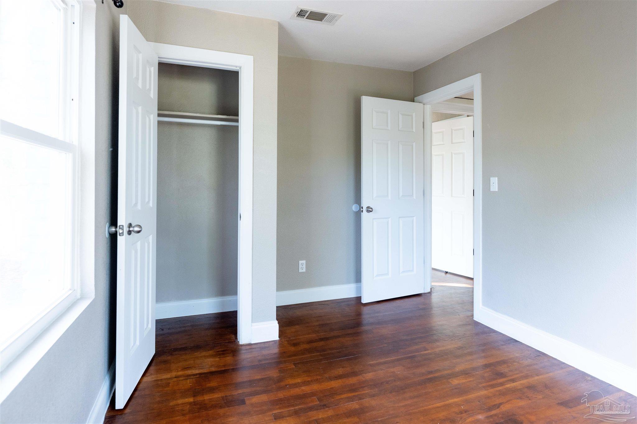 409 Frisco Road Pensacola, FL 32507 - Photo 14 of 27 a view of empty room with wooden floor