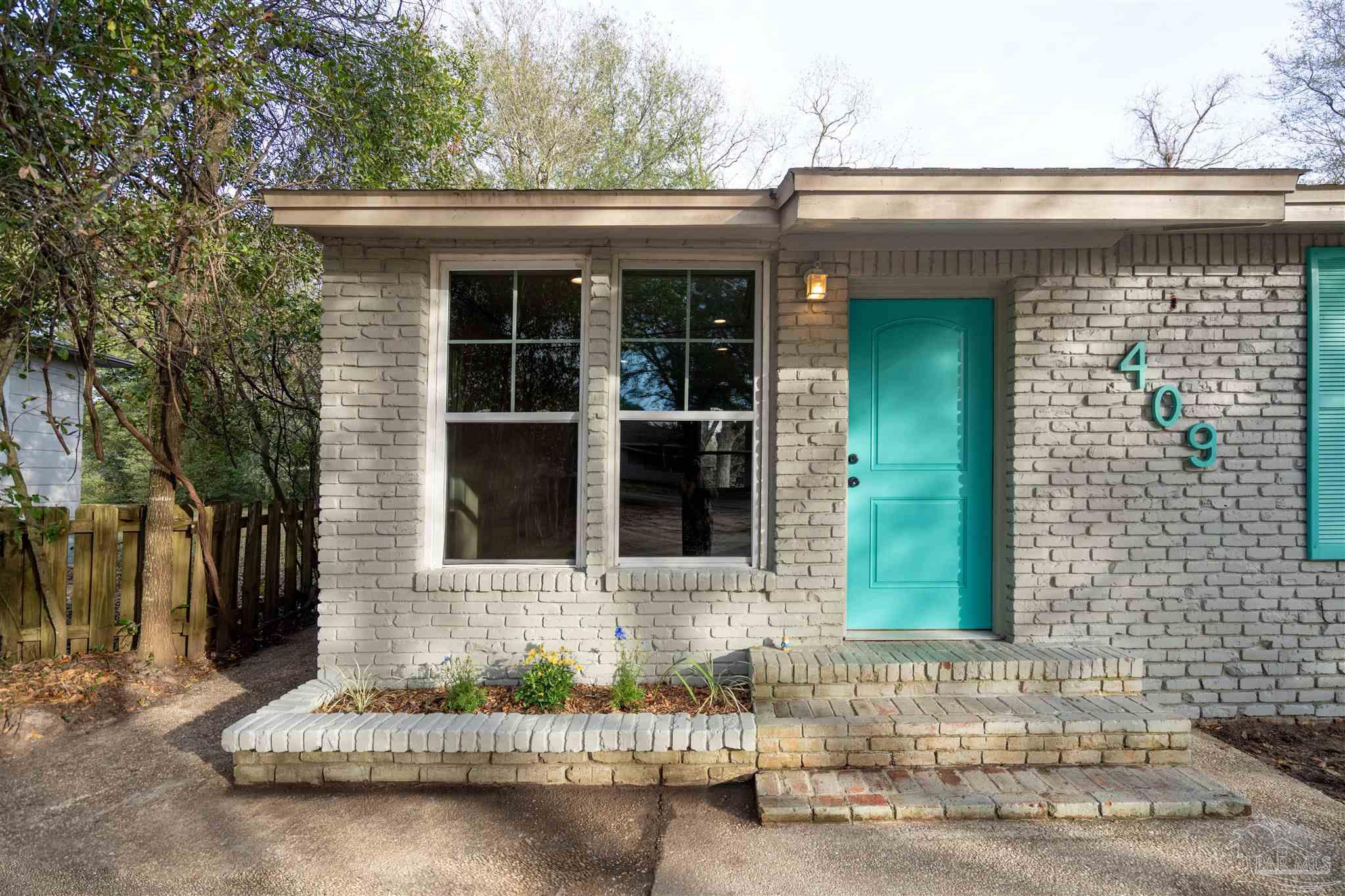 409 Frisco Road Pensacola, FL 32507 - Photo 3 of 27 a front view of a house with a yard