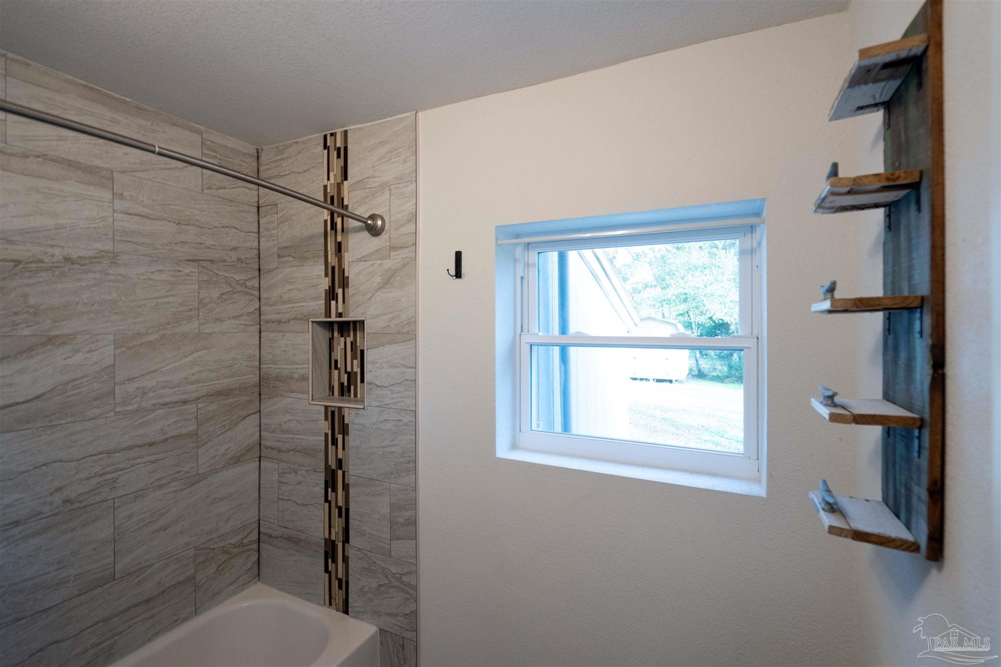 409 Frisco Road Pensacola, FL 32507 - Photo 9 of 27 a bathroom with a toilet and a shower