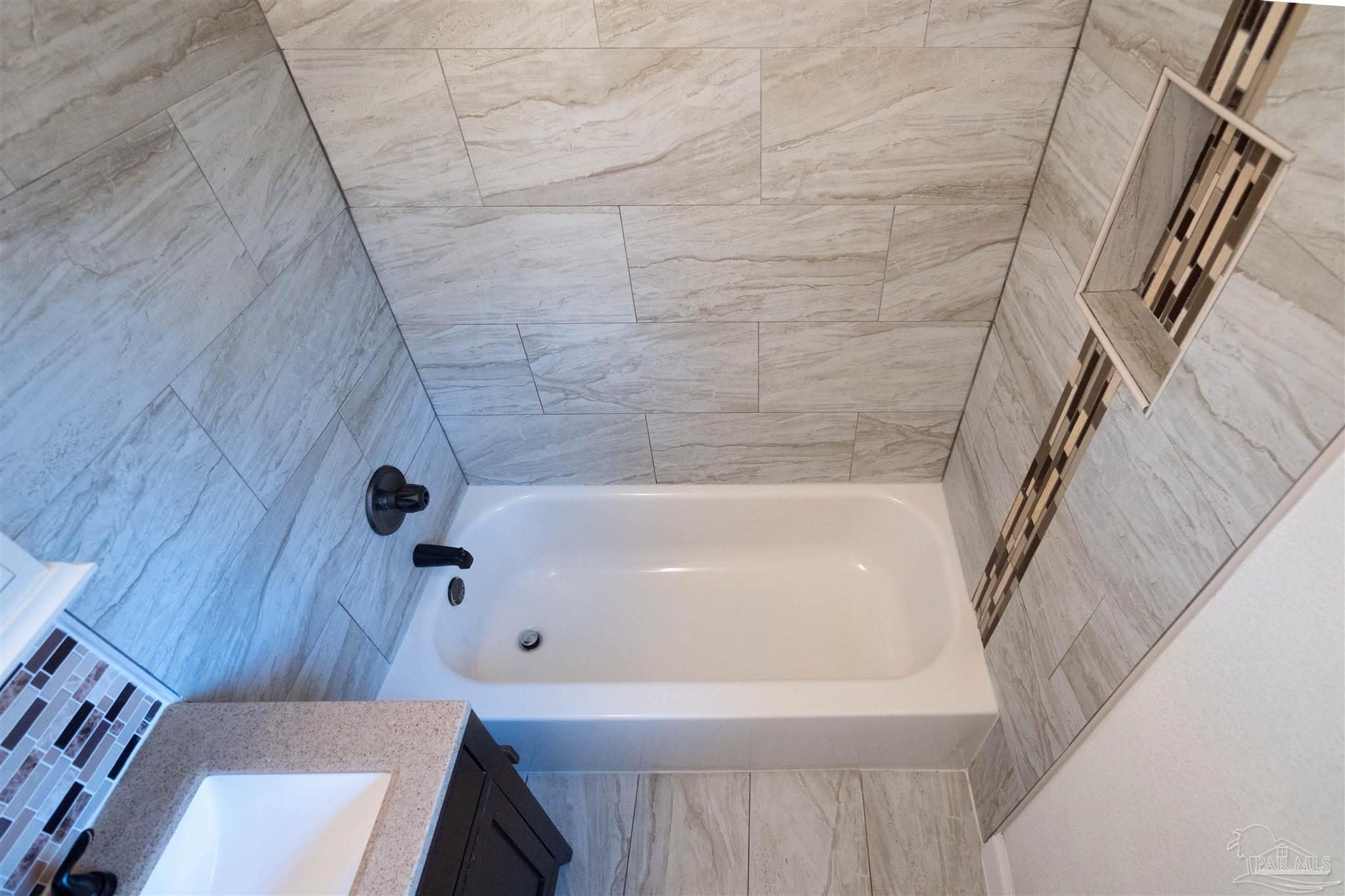 409 Frisco Road Pensacola, FL 32507 - Photo 10 of 27 a bathroom with a tub