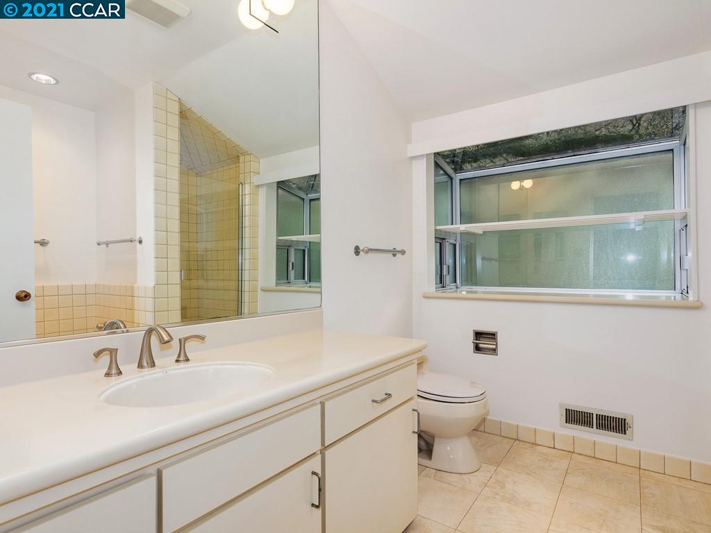 71 Orchard Road Orinda, CA 94563 - Photo 17 of 24 a bathroom with a granite countertop sink toilet and mirror