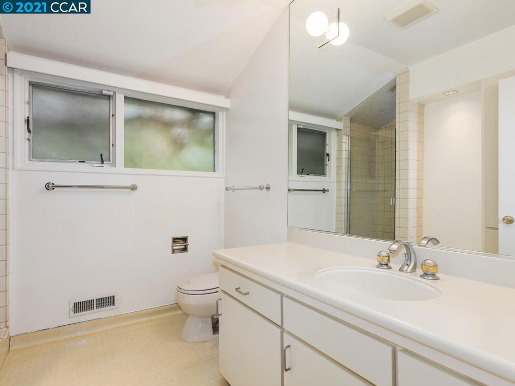 71 Orchard Road Orinda, CA 94563 - Photo 21 of 24 a bathroom with a sink a toilet and a mirror