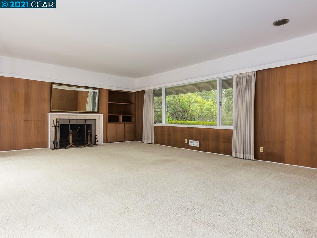 71 Orchard Road Orinda, CA 94563 - Photo 4 of 24 a view of an empty room with a fireplace and a window