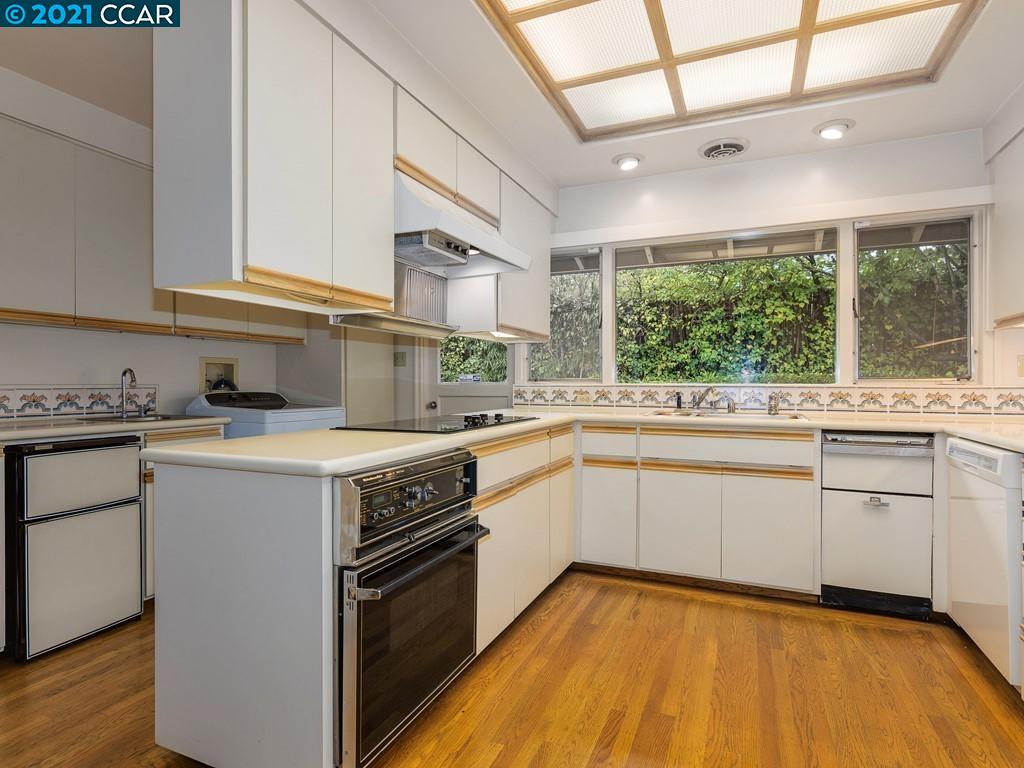 71 Orchard Road Orinda, CA 94563 - Photo 10 of 24 a kitchen with a sink cabinets appliances and a window