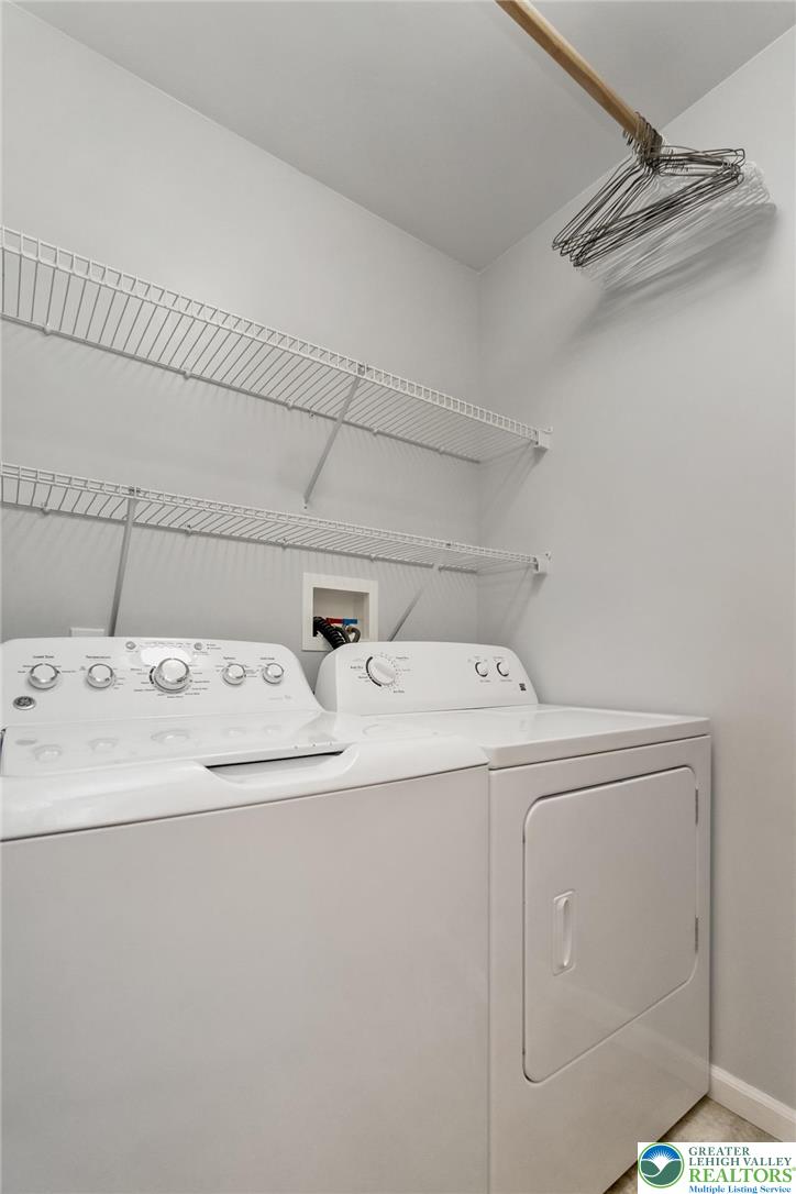 2314 Red Maple Drive Coplay, PA 18037 - Photo 12 of 73 Functional laundry space featuring a washer, dryer, and convenient wire shelving for organization.