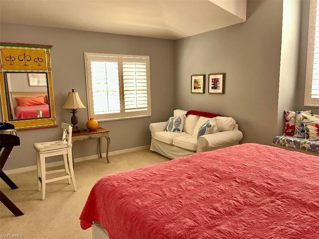 8380 Mystic Greens Way, Unit 1303 Naples, FL 34113 - Photo 16 of 25 a bedroom with two beds and a window