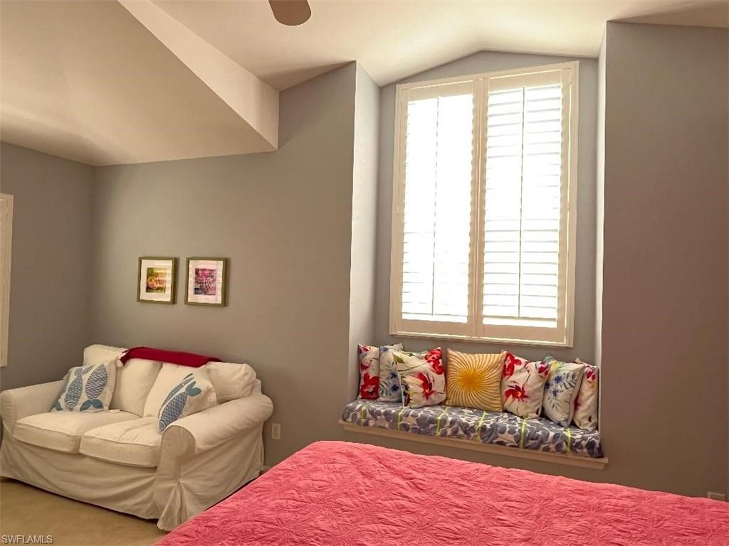 8380 Mystic Greens Way, Unit 1303 Naples, FL 34113 - Photo 17 of 25 a bedroom with bed and a couch