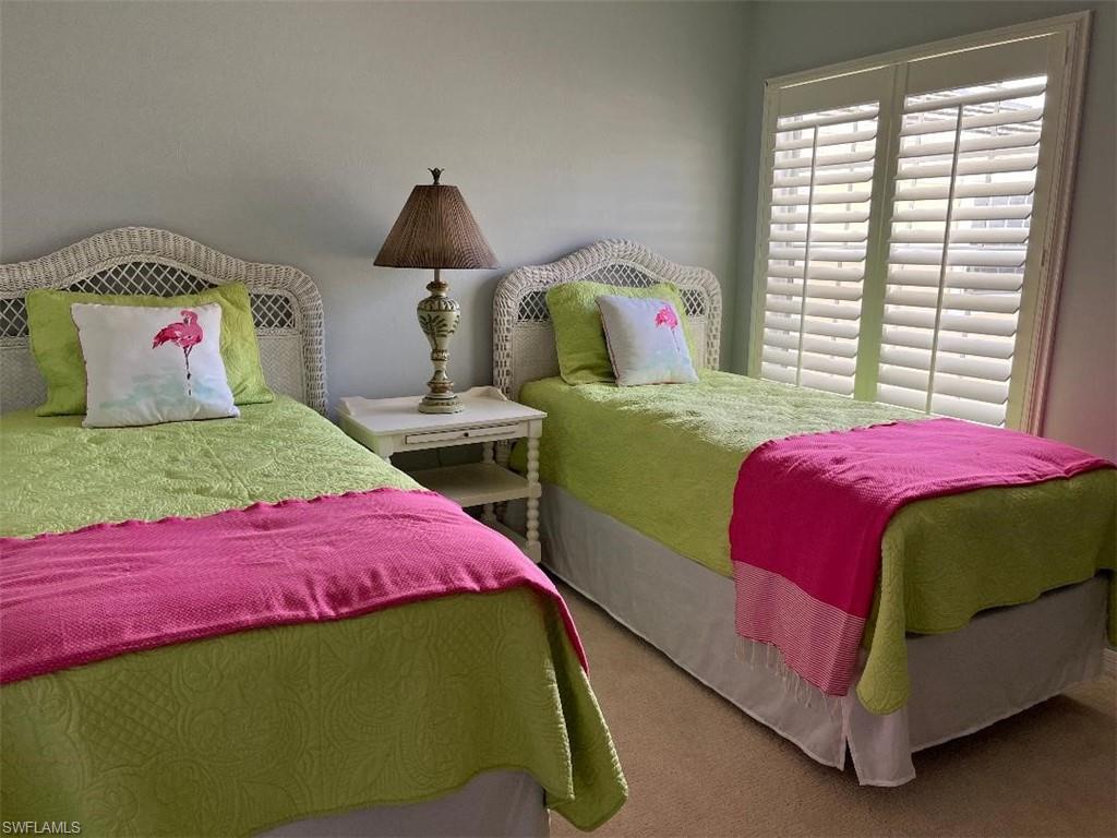 8380 Mystic Greens Way, Unit 1303 Naples, FL 34113 - Photo 19 of 25 a bedroom with a bed and a window