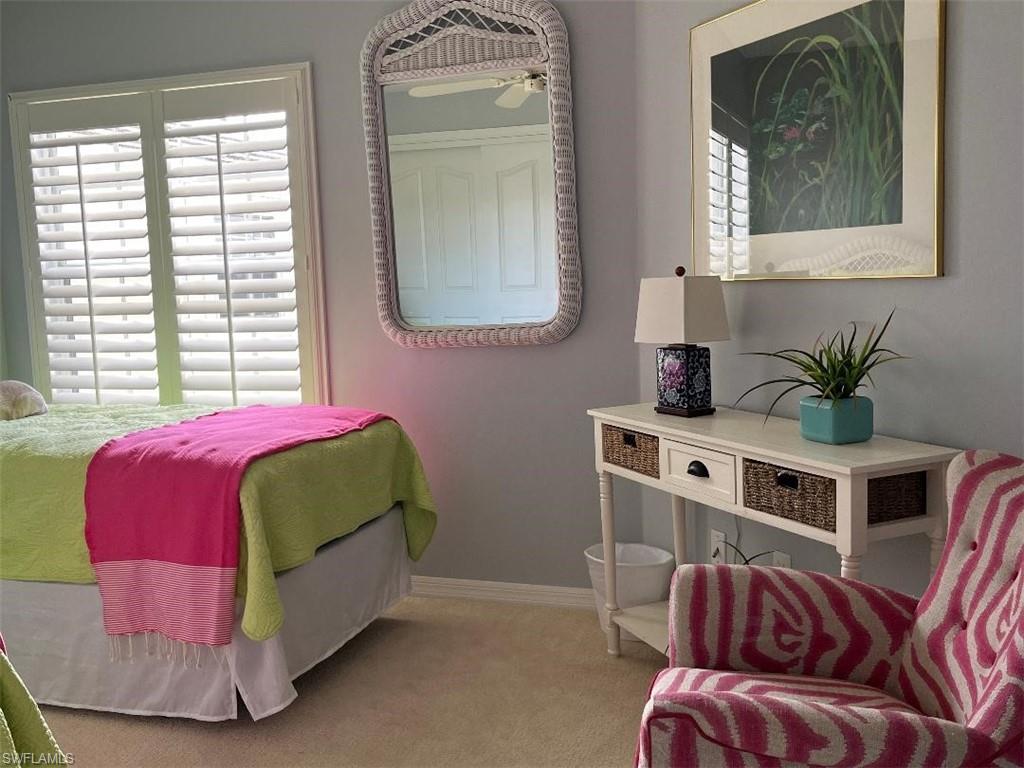 8380 Mystic Greens Way, Unit 1303 Naples, FL 34113 - Photo 20 of 25 a living room with a bed furniture and a window
