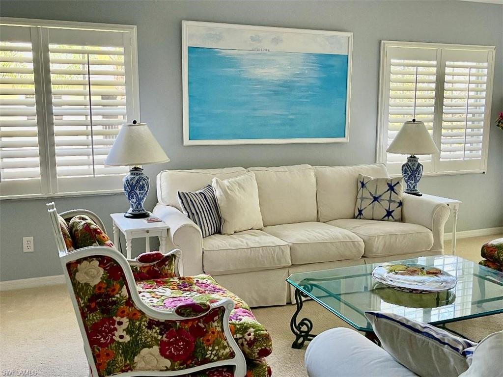 8380 Mystic Greens Way, Unit 1303 Naples, FL 34113 - Photo 2 of 25 a living room with furniture and a large window