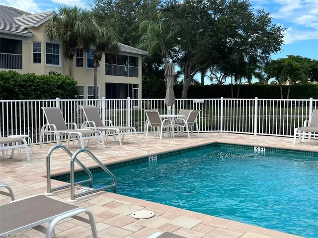 a view of a deck with a chair and a yard