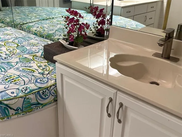 a bathroom with a sink and mirror