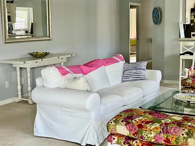 a living room with furniture and painting on the wall