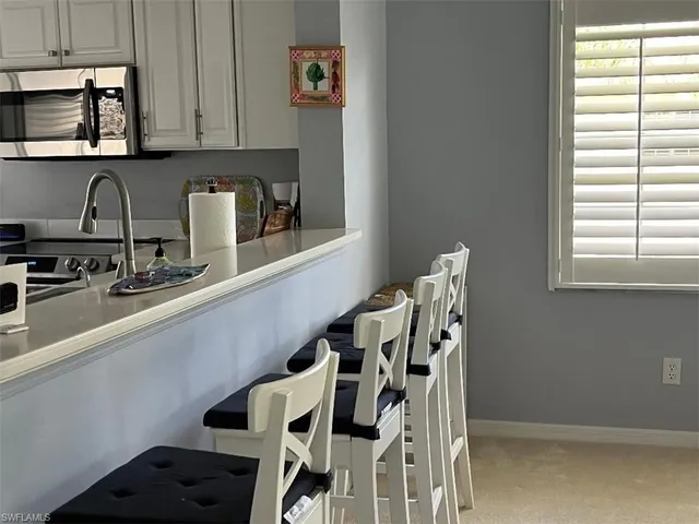 a kitchen with a table and chairs in it