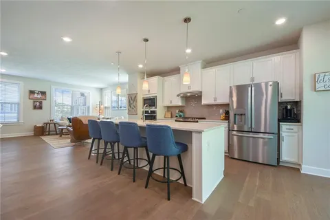 a large kitchen with a table and chairs