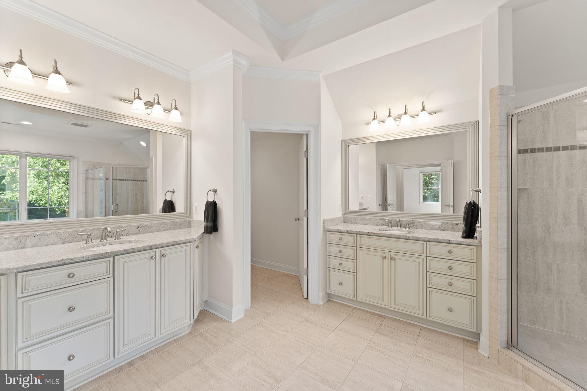 9603 Thistle Ridge Lane Vienna, VA 22182 - Photo 36 of 73 a spacious bathroom with a granite countertop sink a toilet a mirror and shower