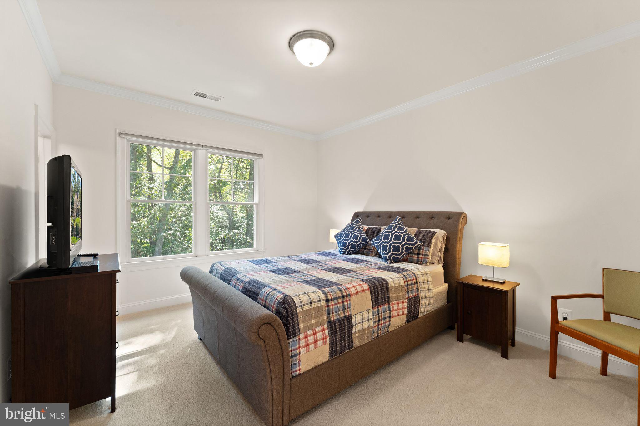 9603 Thistle Ridge Lane Vienna, VA 22182 - Photo 40 of 73 a bedroom with a bed and a dresser next to a window