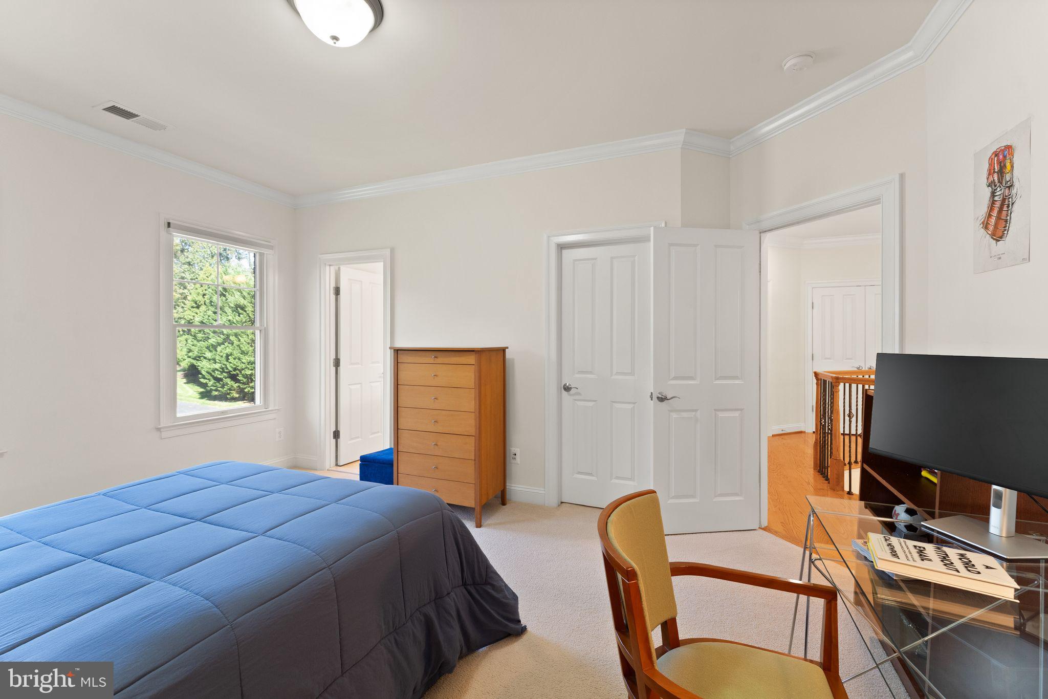 9603 Thistle Ridge Lane Vienna, VA 22182 - Photo 46 of 73 a bedroom with a bed and a flat screen tv